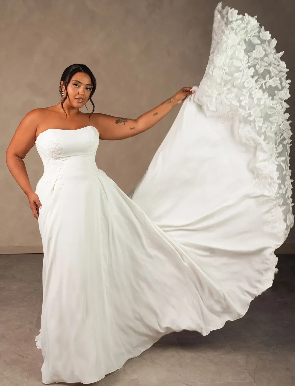 Photo of the model wearing a Plus size gown